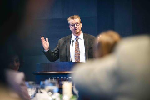 Bob Flowers stands at a podium